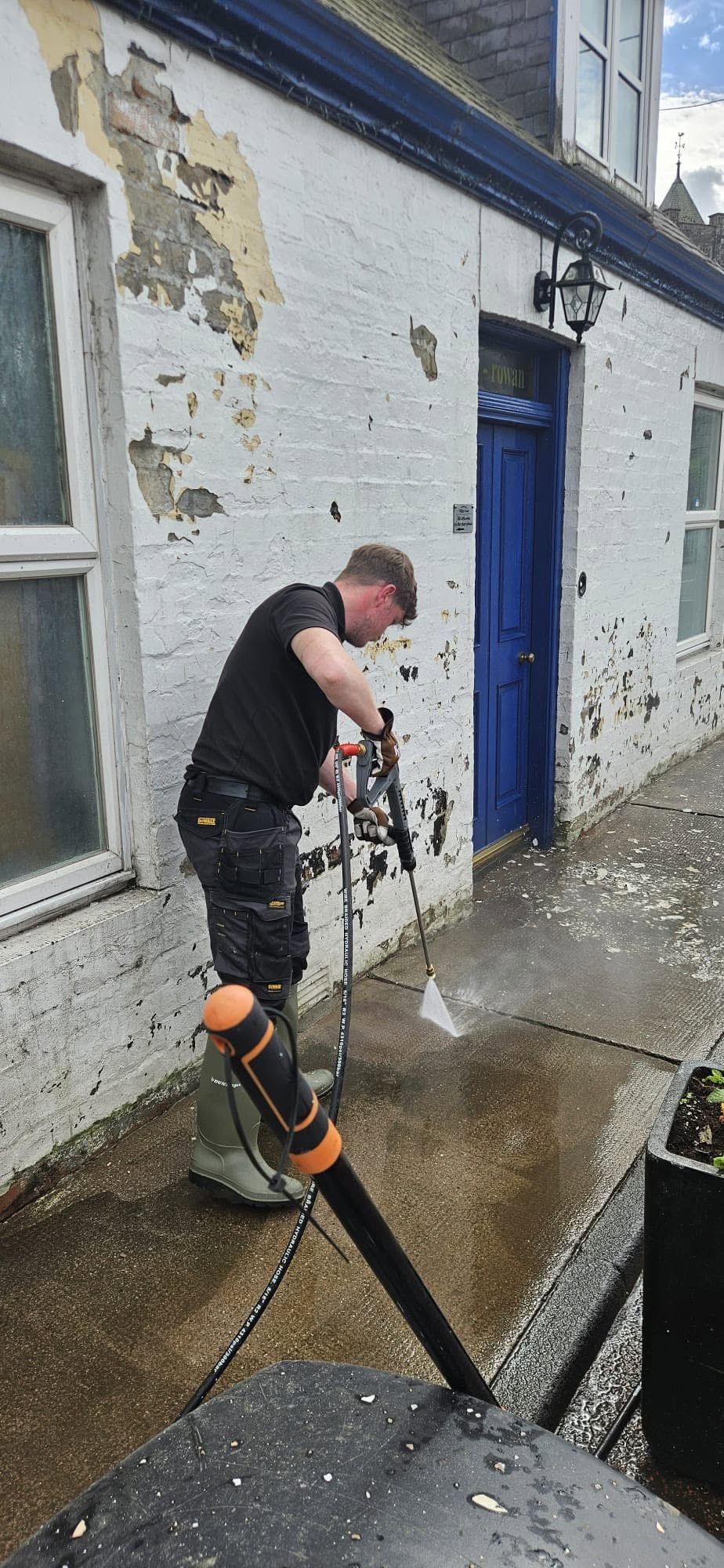 Pressure Washing street of commercial shop