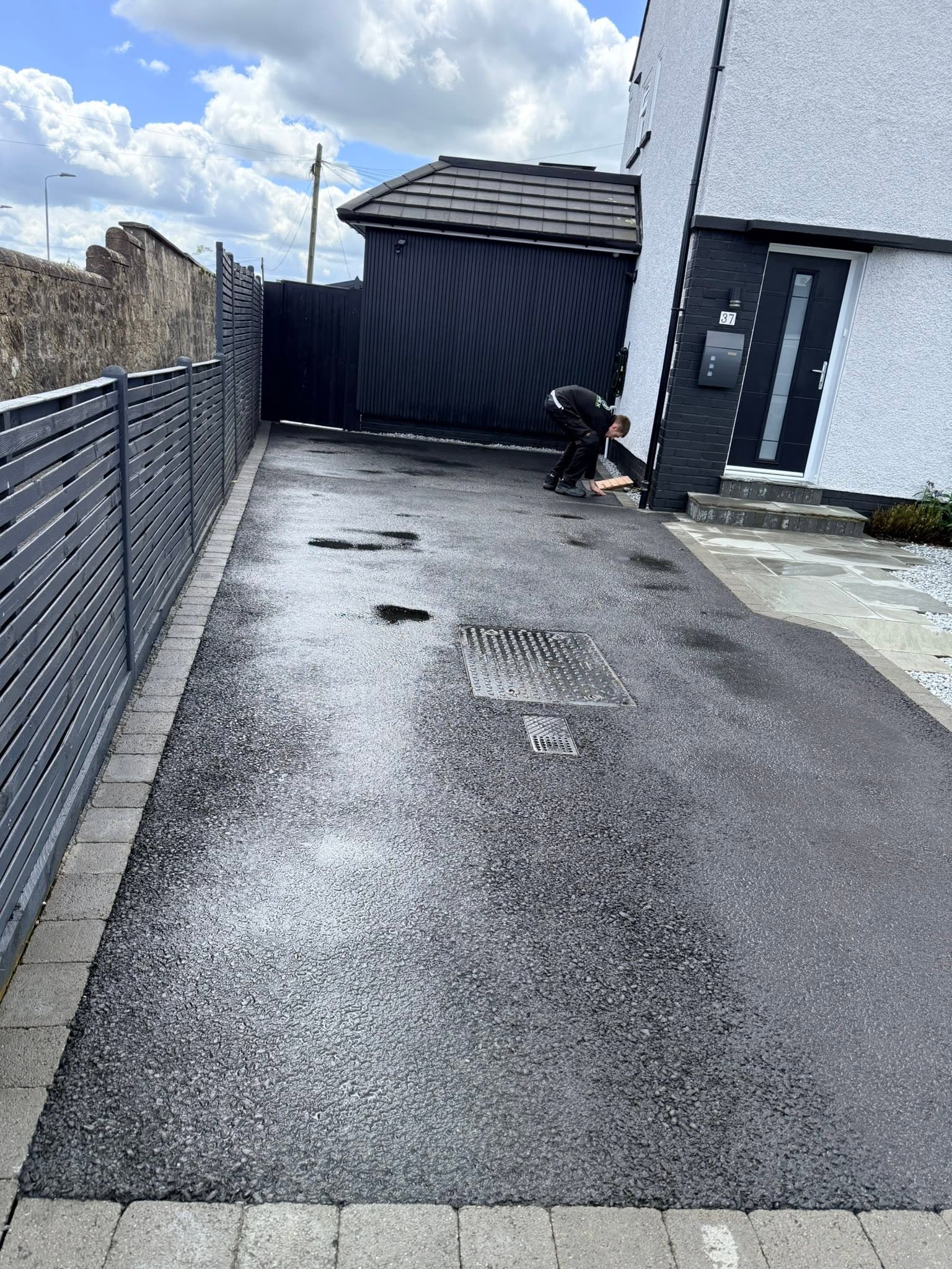 Pressure Washing a driveway leading to garage